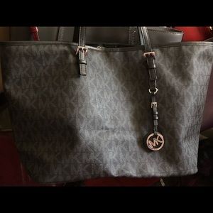 Large Michael Kors Black-on-black bag.